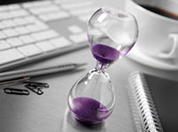 Hour glass on someone's desk to signify time management - Peter Barron Stark Companies