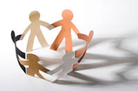 Paper people cut outs holding hands
