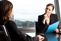 Business Woman listening to employee - coaching - Peter Barron Stark Companies