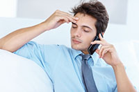 Stressed businessman talking to employee on the phone - Peter Barron Stark Companies
