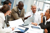 Group of Employees Sitting around a table - peter Barron Stark Companies
