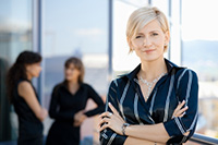Woman standing cross-armed - peter barron stark companies