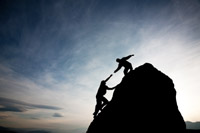 Two people climbing up a mountain as a symbol of change - peter barron stark companies