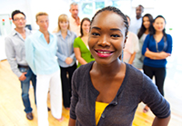Woman standing in front of her team - Moving from Peer to Supervisor