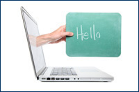hand appearing out of a laptop screening holding a sign which says Welcome