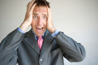 Man holding his ears and screaming
